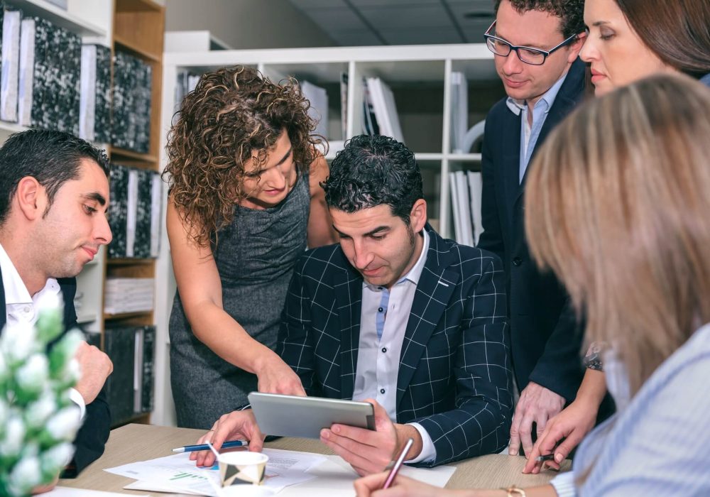 teamwork-looking-business-document-in-electronic-tablet-1.jpg
